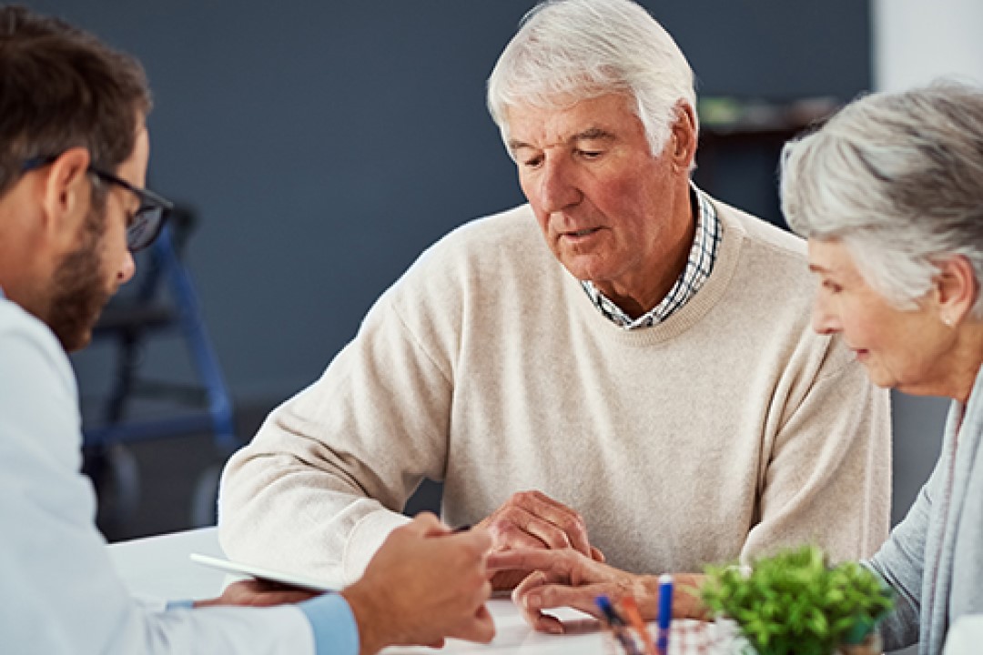 Älterer Mann und Frau in Besprechung mit Arzt