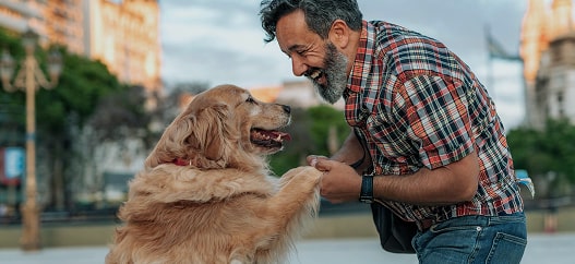 Uomo che gioca col proprio cane in un piazzale